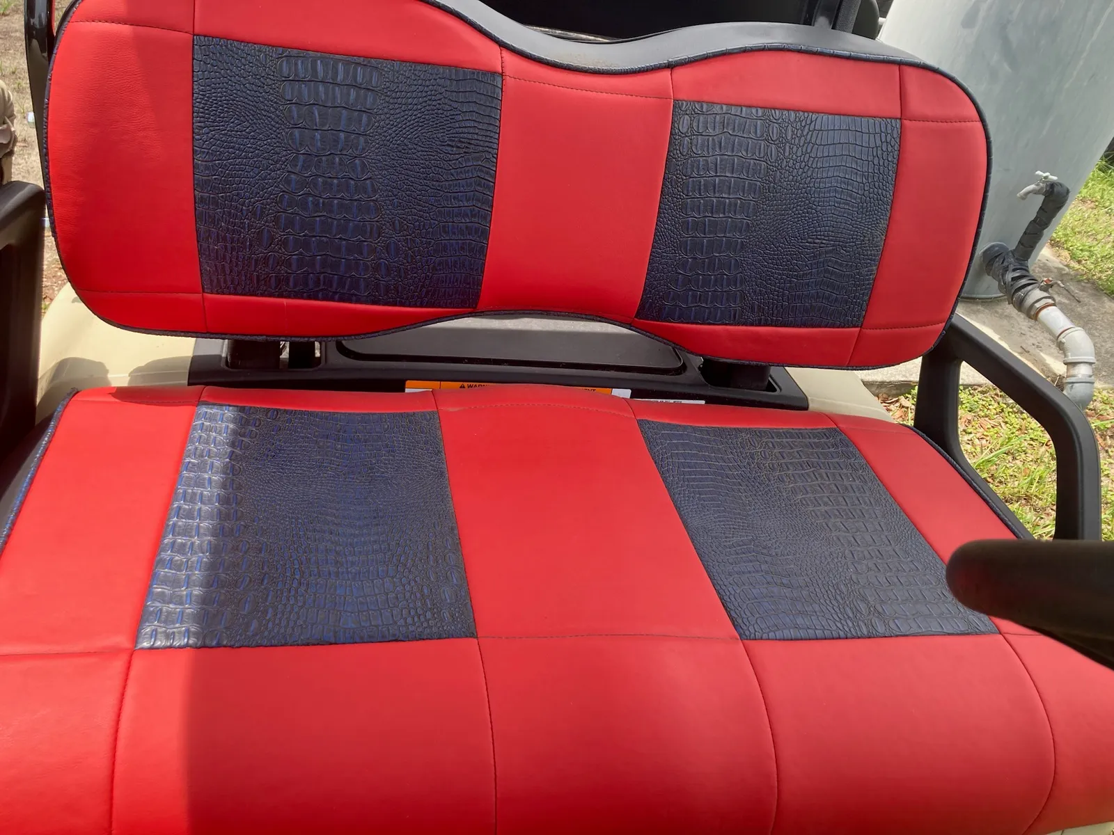 Red golf cart seat with black gator-embossed inserts