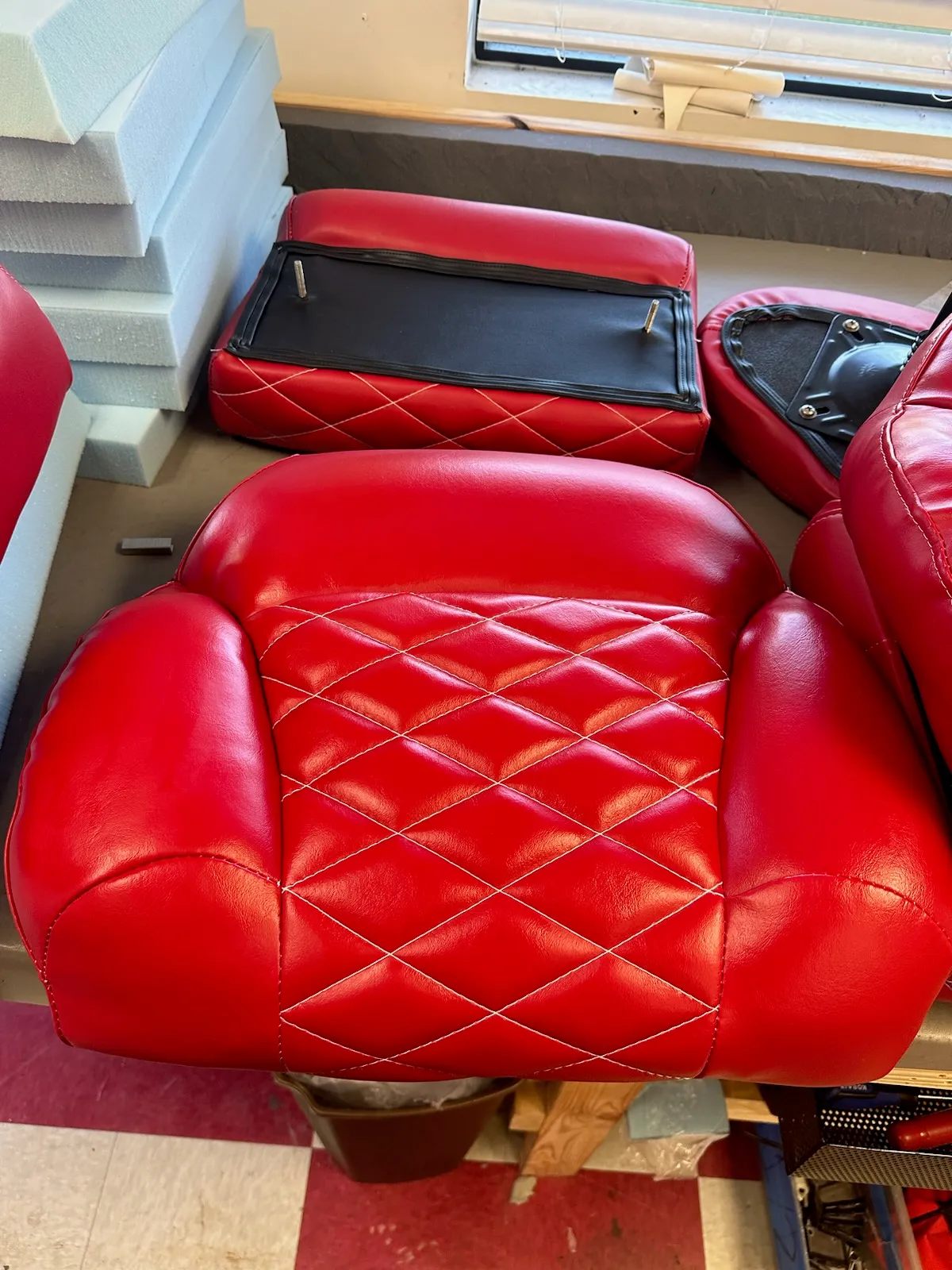 Bright red diamond-stitched seat cushions in the shop