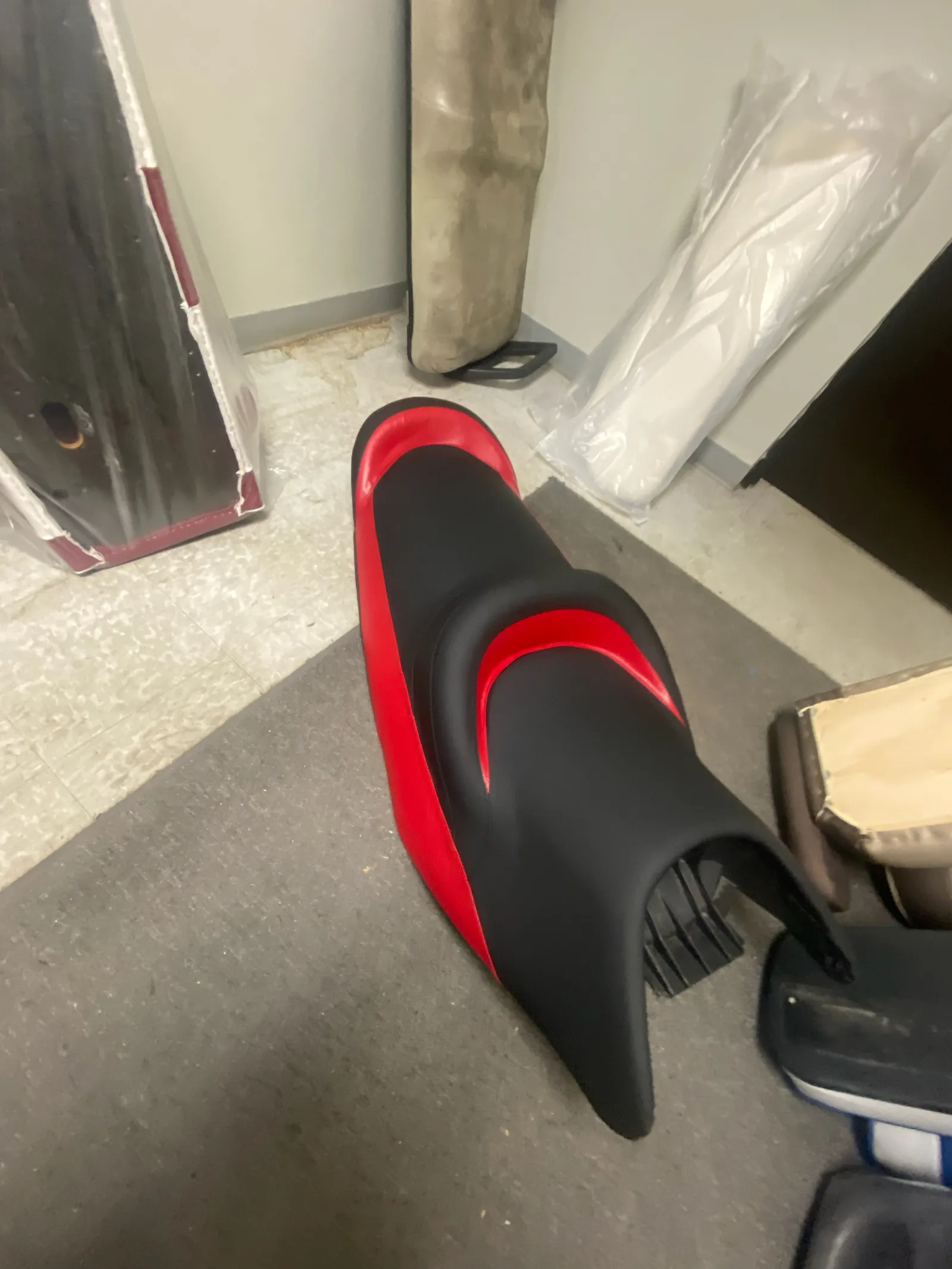 Freshly reupholstered black and red jet ski saddle seat