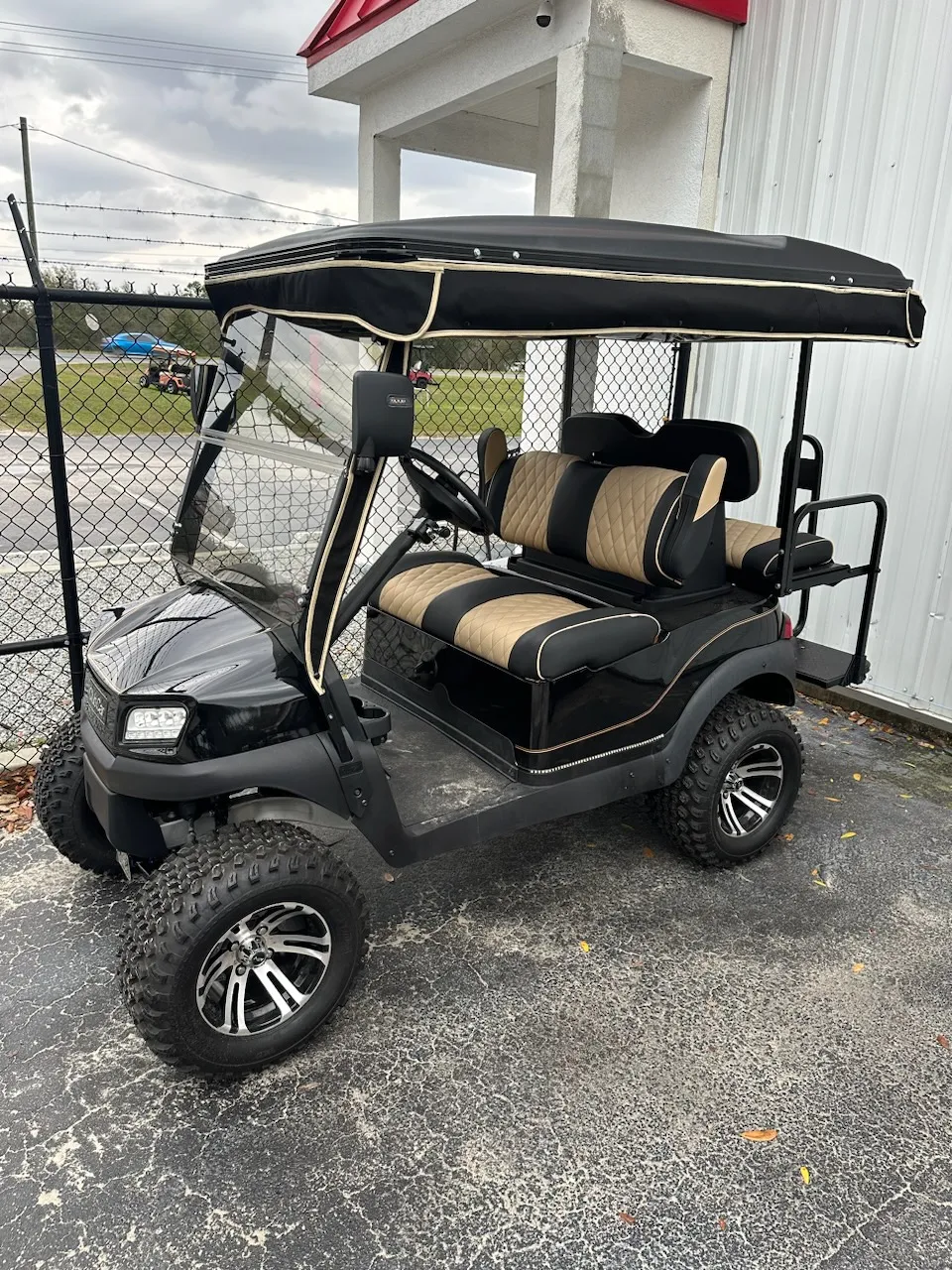 Black and tan diamond-pleated seats on lifted black cart