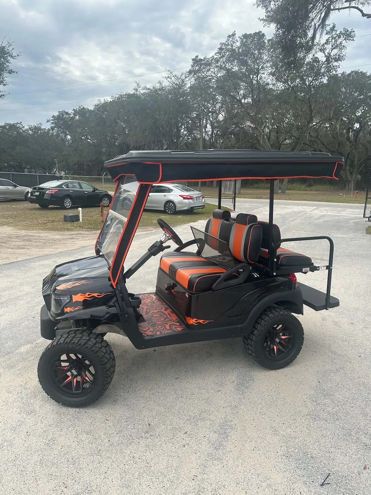 Orange and black striped seats on flame-painted lifted cart