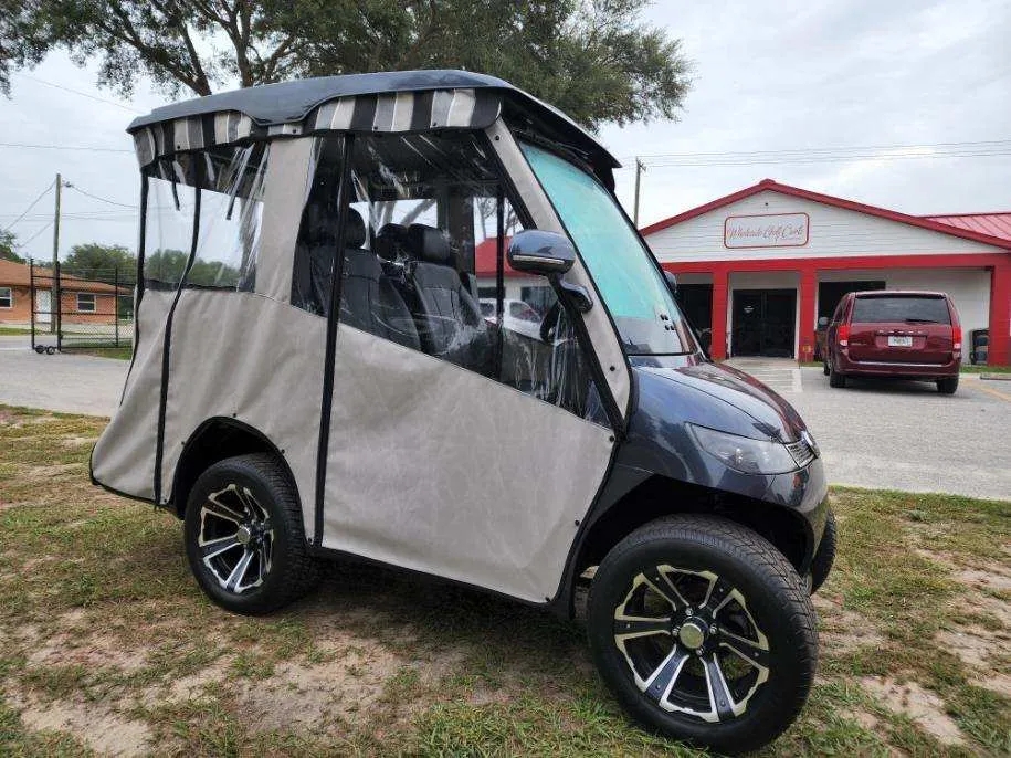 Tan full golf cart enclosure with striped valance and clear windows