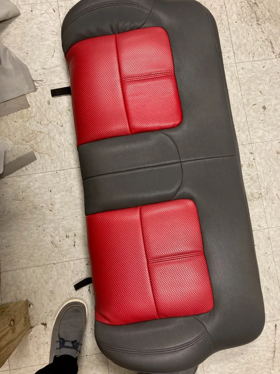 Gray bench seat with perforated red inserts