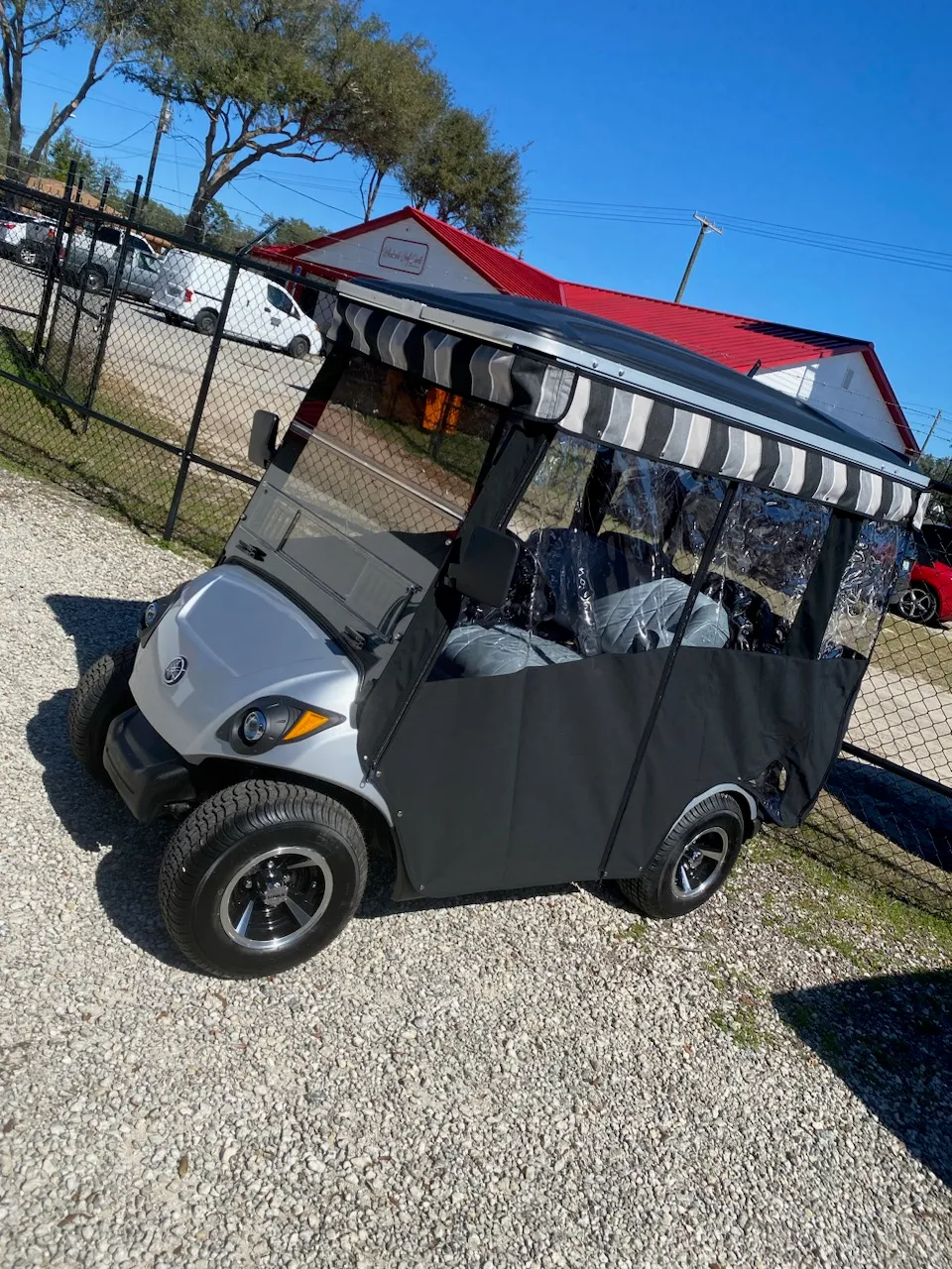 Black enclosure with striped valance on silver Yamaha cart