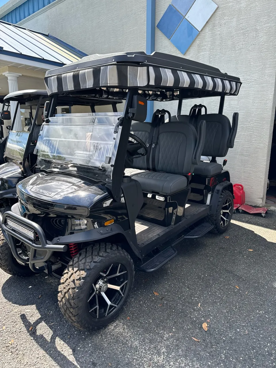 Black lifted cart with striped canvas canopy top