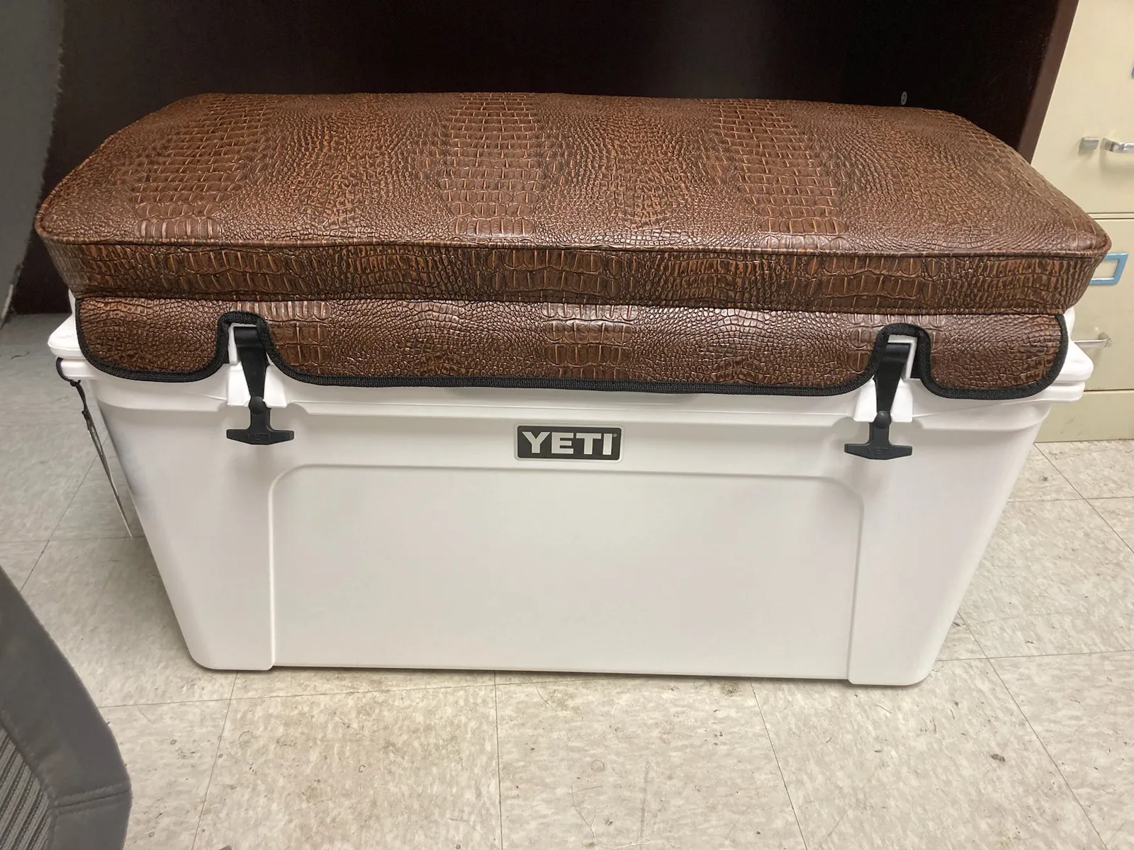 Brown gator-embossed cushion cover on white YETI cooler