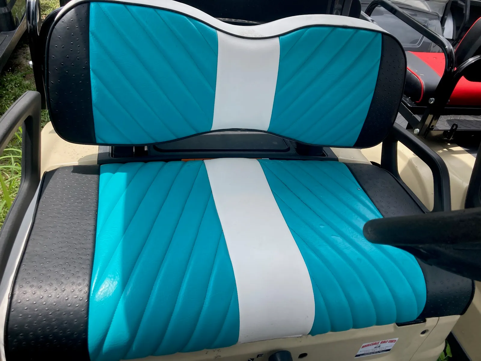 Teal and white pleated golf cart seat with ostrich trim